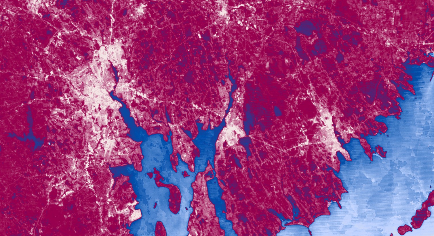 Land surface temperature averages for 2014 through 2018 derived using the new Landsat Level-2 Provisional Surface Temperature product (Landsat 7 ETM+ and Landsat 8 OLI). This image is focused on Providence, RI, and was used to assess urban heat within the city. Higher surface temperatures appear lighter pink; lower surface temperatures appear deeper pink. The blue areas represent the water surrounding the area.
