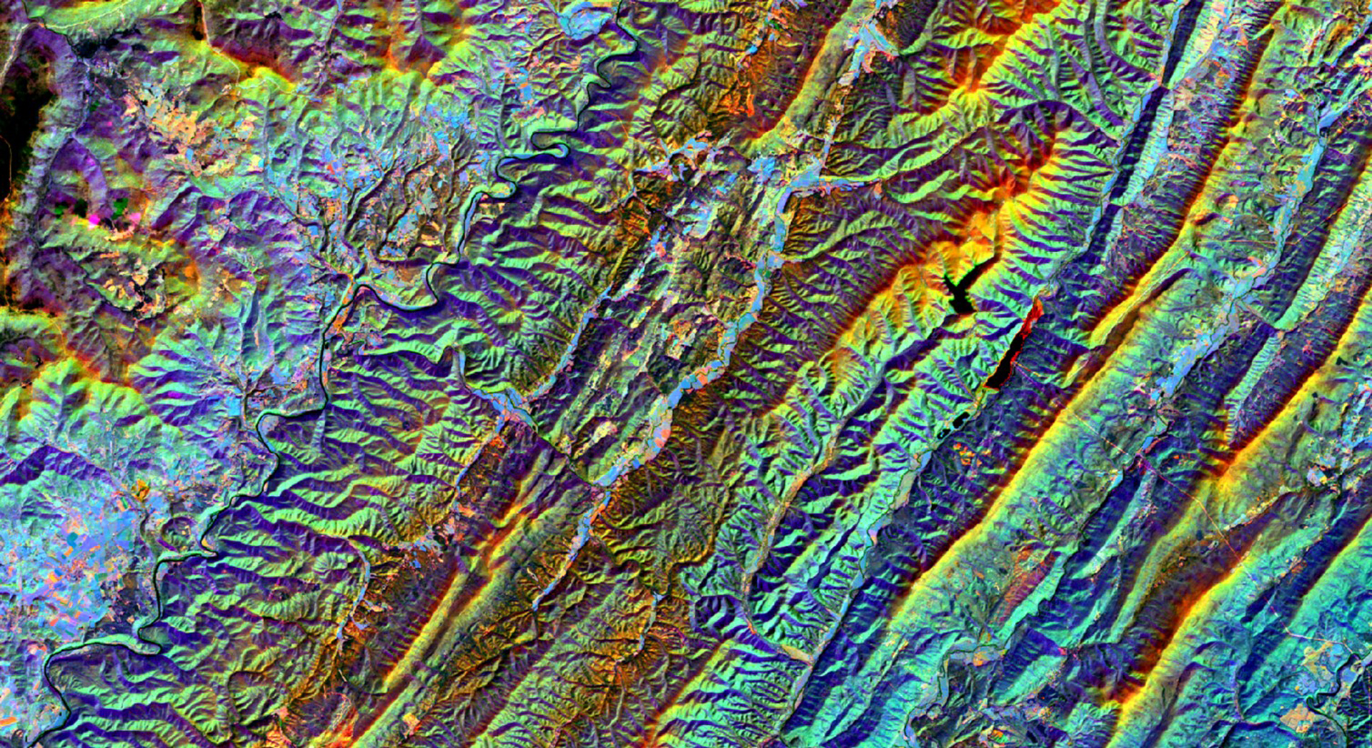 Split-season composite from May (leaf-on) and November (leaf-off) 2018 in the Allegheny Mountains of West Virginia. This Landsat 8 OLI imagery displays a color combination of SWIR_1 (leaf-on), SWIR_1 (leaf-off), and NIR (leaf-on). Urban areas are shown in pink, impervious surfaces in periwinkle, conifer forests in dark green, and exposed soil in orange. This stack, and others like it, are used for determining land cover classifications and collecting training data for forest restoration efforts.