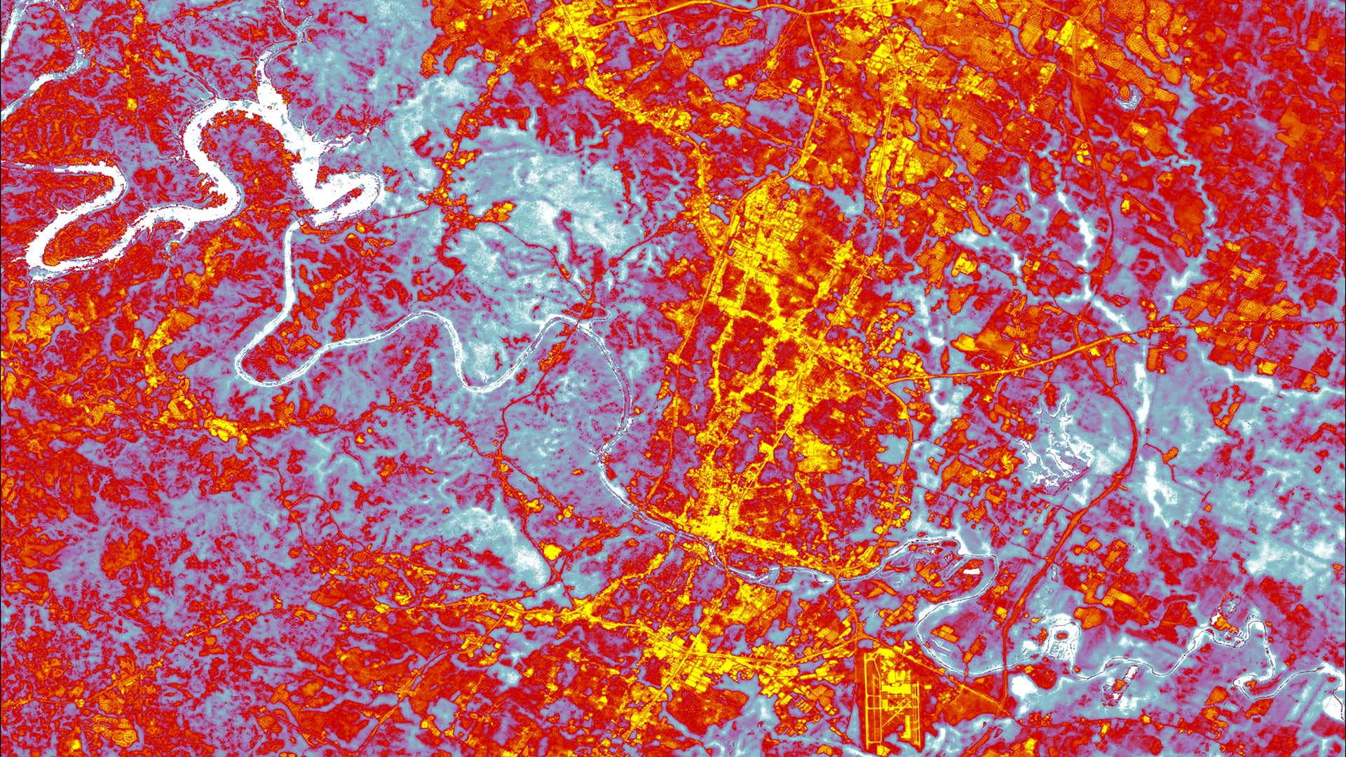 Daytime average land surface temperatures calculated from April-September, 2015 – 2020 Landsat 8 TIRS data. The image shows downtown Austin, Texas, the surrounding Hill Country, and Lake Travis. Red and yellow values represent highest temperatures, while blue and white values depict cooler areas, including the Colorado River system that runs through the city. Yellow areas highlight built-up features associated with higher temperatures, suggesting where partners should focus their efforts on mitigating heat hazards for vulnerable communities.Keywords: Urban Heat, Land Surface Temperature, Landsat8, Alexa Lopez, Will Peters, Margaret McCall, James Sanders