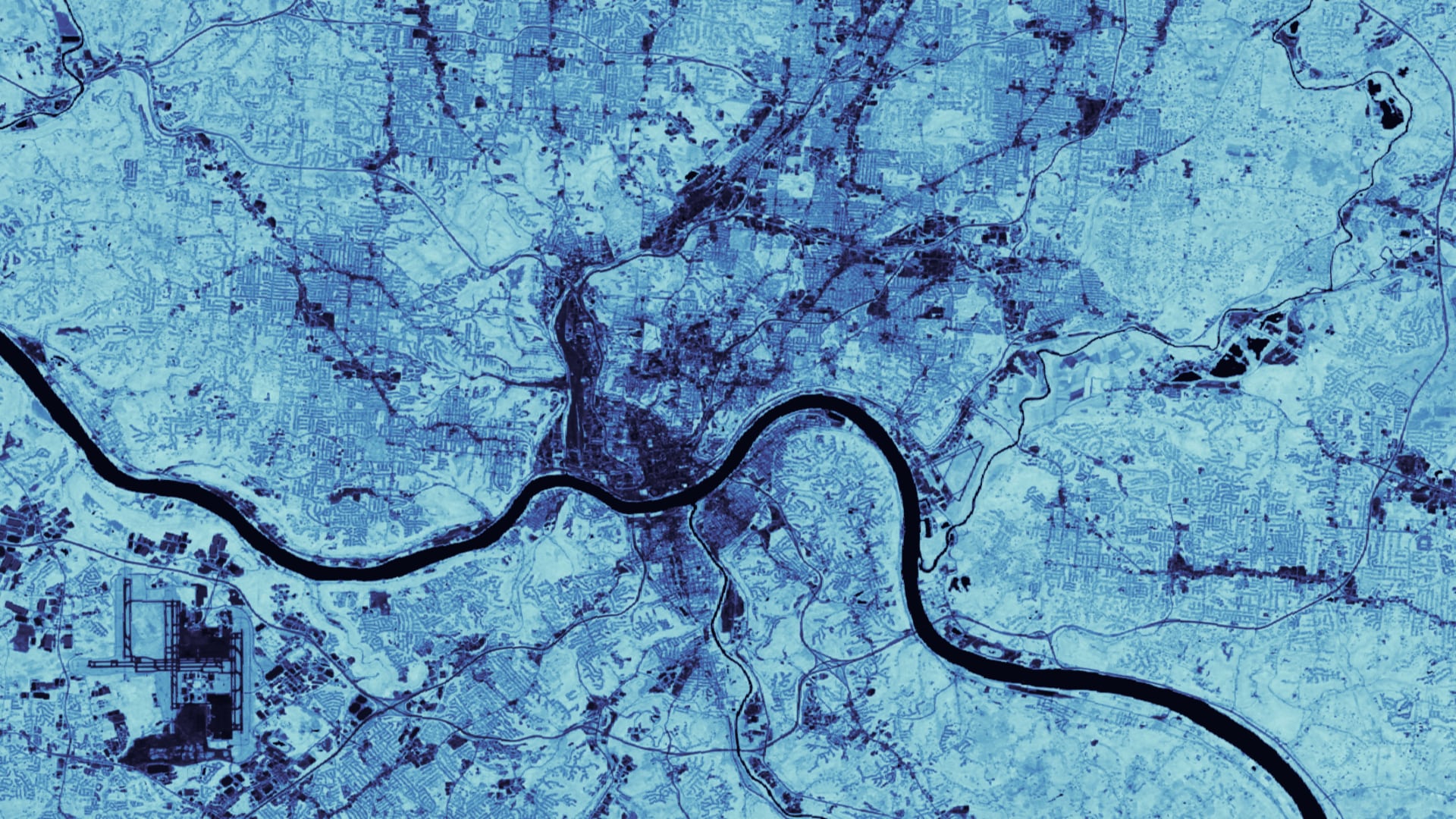 NDVI-processed imagery from 2020 Landsat 8 OLI data of the greater Cincinnati, OH and Covington, KY area. Lighter blues show denser vegetation while darker blues depict highly urbanized areas. The darkest blue line represents the extent of the Ohio River. Urban areas lacking slope-stabilizing and run-off retaining vegetation are more susceptible to landslides and flooding.Keywords: NDVI, landslide susceptibility, InVEST, urban flood mitigation